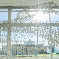 Hundreds of stainless steel spheres that make up the sculpture gleam in the sunlight