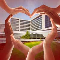Hands making a Heart in front of UT Southwestern