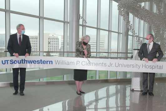 Three UT Southwestern leaders cut the ceremonial ribbon inside the second floor lobby of the new Clements University Hospital tower