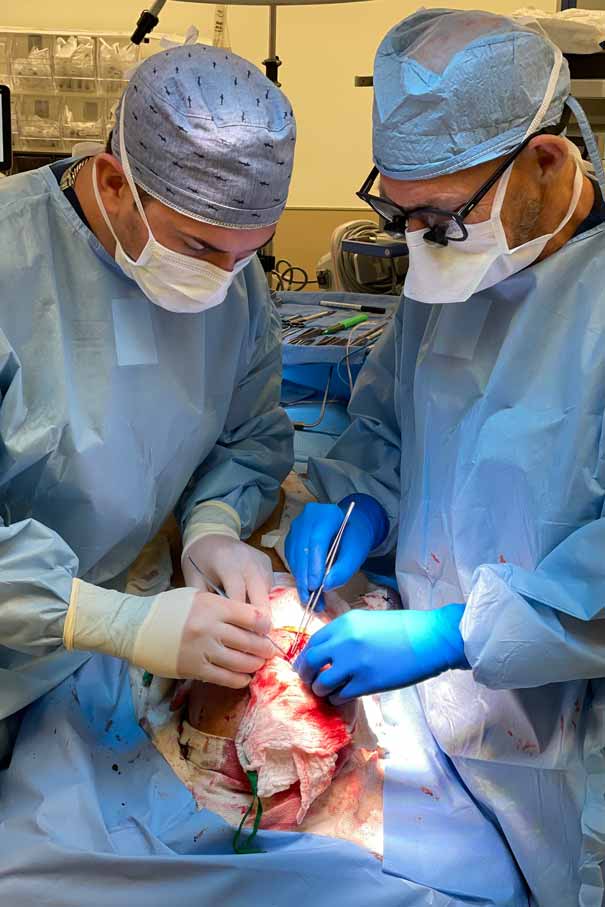 Dr. Ian Wisecarver and Dr. James Thornton perform a surgical procedure on a patient in the operating room