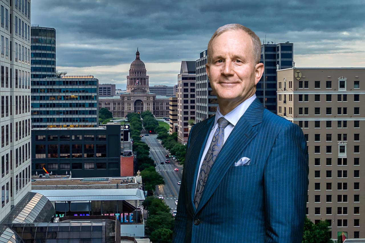 Rick Snyder standing on a balcony overlooking downtown Austin, Texas, and the street leading to the Texas State Capitol.