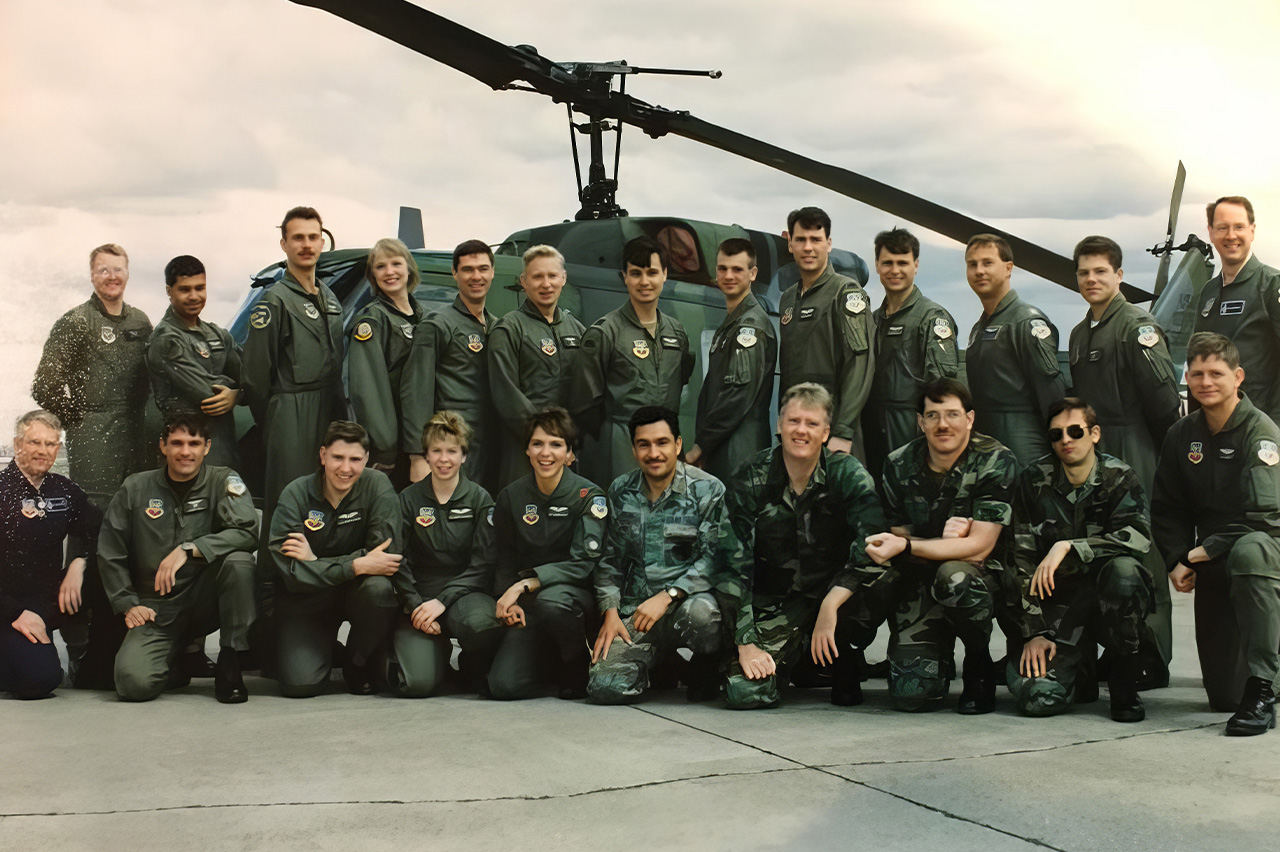 Gladys Young with her rescue team unit all in Air Force uniforms standing in front of a helicopter