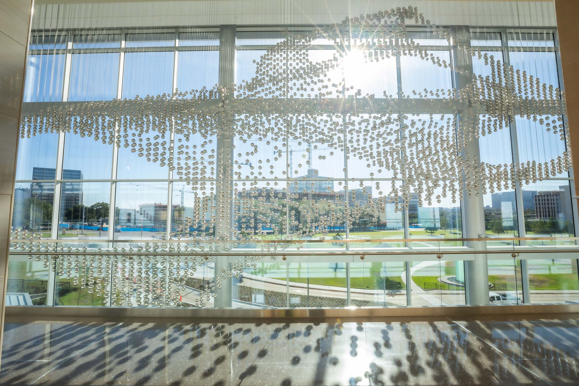 Sculpture made up of thousands of reflective steel balls hung from thin steel wires.