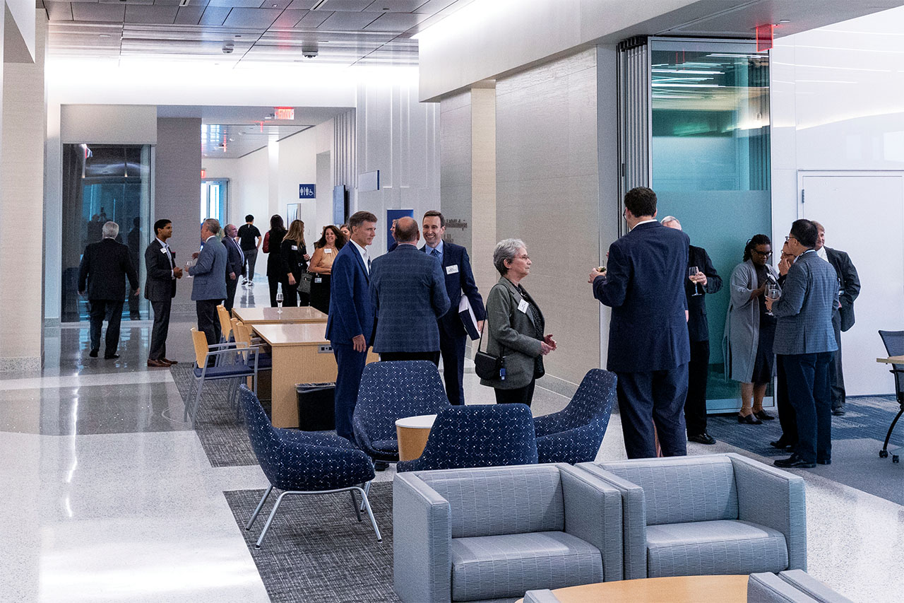 Guests standing and talking in the lobby of the new facility.