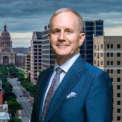 Rick Snyder standing on a balcony overlooking downtown Austin, Texas, and the street leading to the Texas State Capitol.