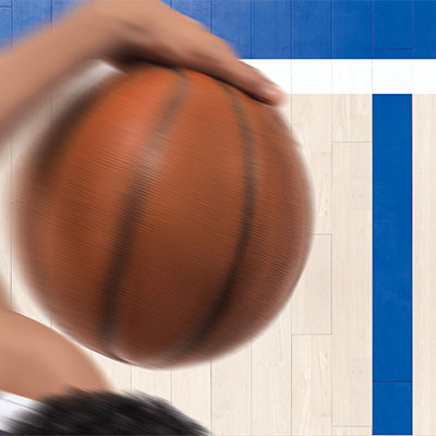 An aerial close-up view of a basketball player's arm holding a basketball.