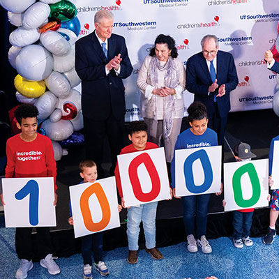 Surrounded by children and community members, Children’s Medical Center Foundation President Brent Christopher, at the podium, announces the Pogue family’s gift at Children’s Medical Center Dallas.