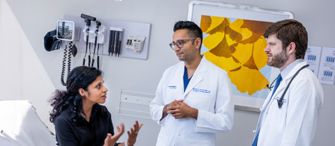 a patient talking to doctors in a clinic setting