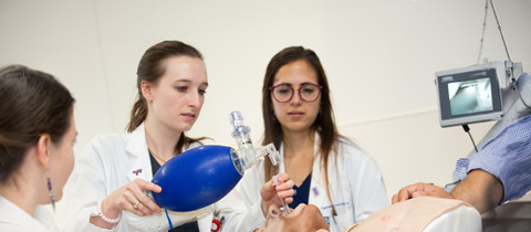 medical students practicing providing care to a dummy